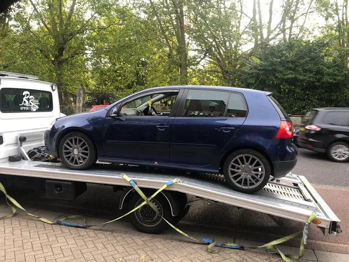 Car being towed by a recovery vehicle in London